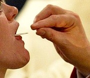 **FILE**Sister Mary Andrea, of the Sisters of St. Francis of the Martyr in St. George, left, takes communion from Archbishop Raymond Burke in this Monday, Jan. 26, 2004 file photo at the Cathedral Basilica in St. Louis. Archbishop Burke said in January he would deny the sacrament of communion to John Kerry, a Catholic who supports abortion rights. But scores of leading Roman Catholic politicians across the country appear undaunted by election-year warnings from bishops that those who support abortion rights may be unworthy to receive Holy Communion.(AP Photo/St. Louis Post-Dispatch, Huy Richard Mach, File)